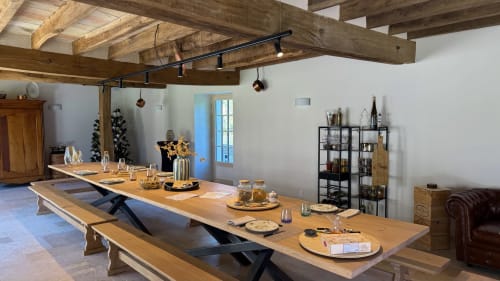Rustic dining hall at Cloffy B&B in Nouans-les-Fontaines with wooden beams, long tables, and elegant place settings