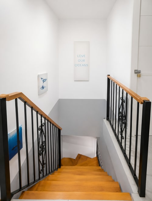 Staircase in Manage Home Tenerife luxury penthouse with ocean artwork and 'Love Our Oceans' wall art