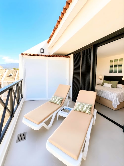 Luxury penthouse balcony with lounge chairs and sea view in Playa de las Américas, Tenerife