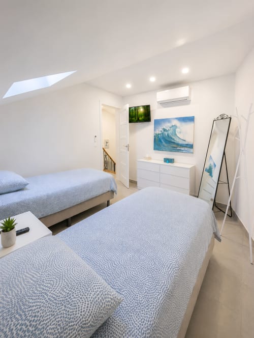 Modern twin bedroom with skylight at Manage Home Tenerife luxury penthouse in Playa de las Américas