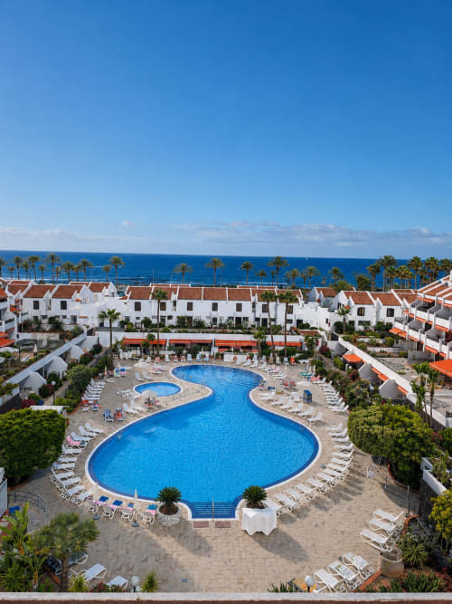Luxury resort pool complex with ocean view in Playa de las Américas, Tenerife