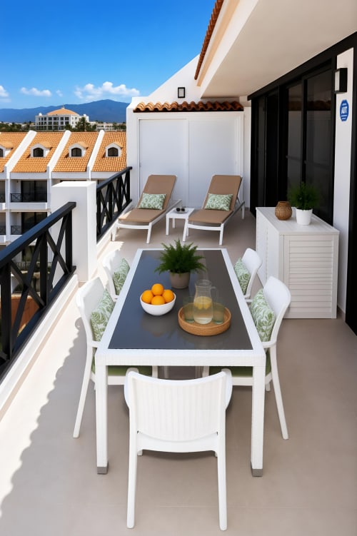 Luxury penthouse terrace in Playa de las Américas with dining table, loungers, and mountain views, Tenerife