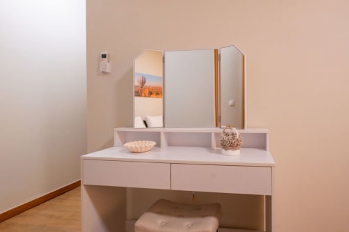 Modern white vanity with mirror and storage at EcoHost apartment in Porto, Portugal