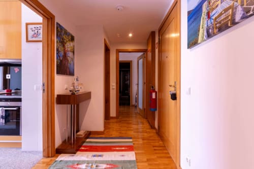 Modern hallway with wooden doors and flooring at OceanBreeze apartment in Matosinhos, Portugal