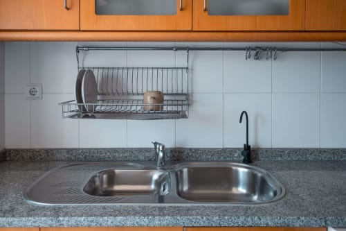 Modern kitchen sink with dish rack in EcoHost apartment, Matosinhos Portugal