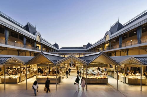 Modern marketplace with golden-lit vendor stalls, arched architecture, and symmetrical design in Matosinhos
