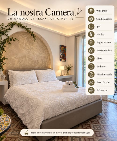 Camera elegante con testata ad arco, biancheria bianca e illuminazione ambientale presso Kalsa B&B a Catania, WiFi, TV