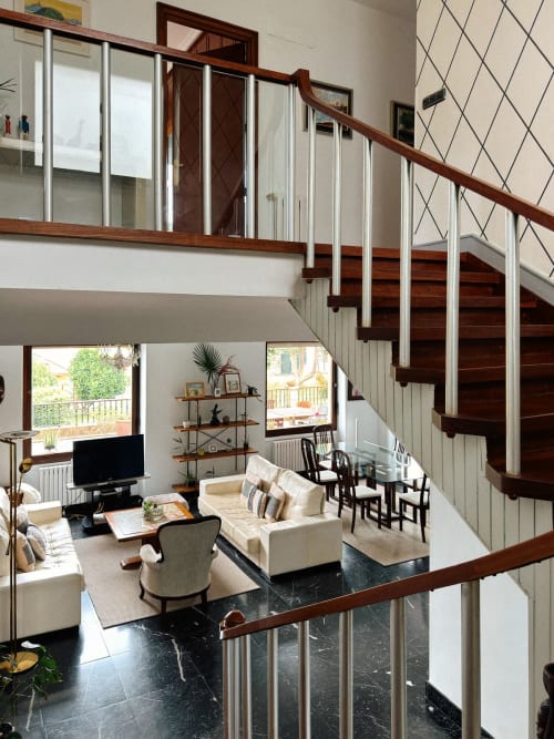 Modern loft interior at Casa Señorial Sasueta in San Sebastián with wooden staircase and contemporary furnishings