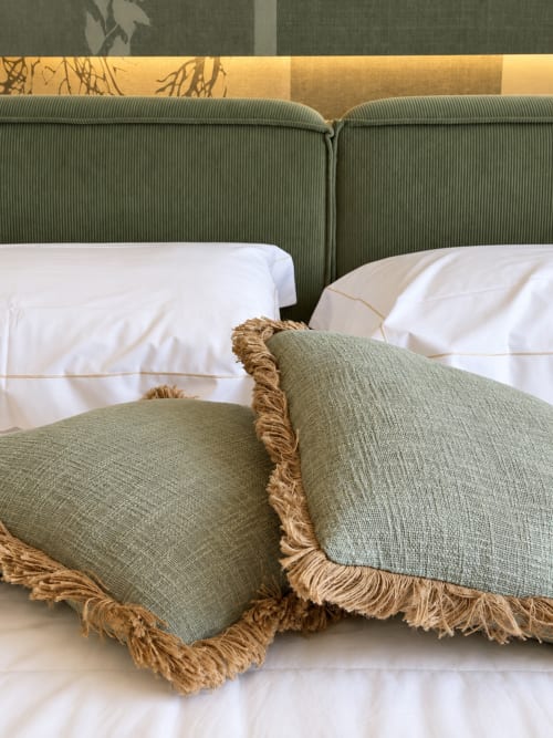 Letto lussuoso a Domus Fysi Palermo con testata verde, biancheria bianca e cuscini bordi oro con frangia