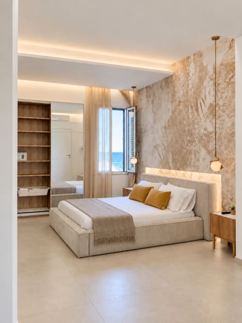 Suite moderna con vista sul mare presso Domus Fysi a Palermo: letto beige, parete in marmo e balcone affacciato sull'oceano