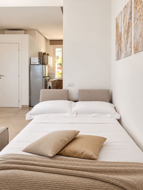 Luminosa camera con letto bianco, angolo cottura e vista mare presso Domus Fysi Palermo, Suite Sole e Luce