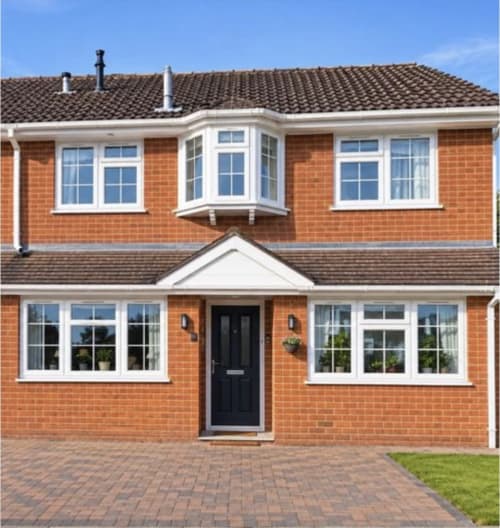 Modern two-story brick home with white-trimmed windows at OD Cribs Meadow View, Guzape Abuja