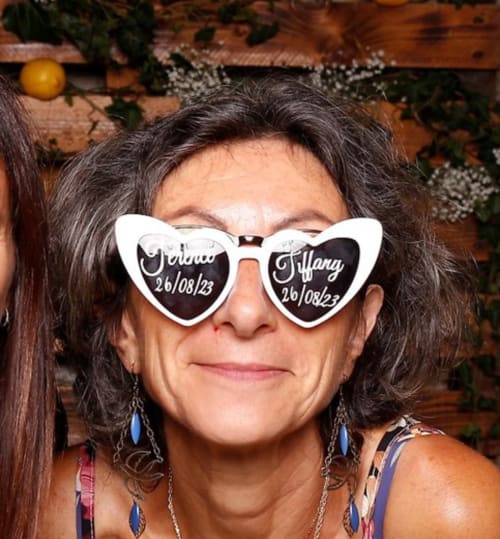 Woman wearing heart-shaped novelty glasses at Le Jardin de la Reyssouze, a bed and breakfast in Gorrevod, France