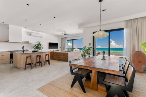 Beachfront cottage in Isla Mujeres with open-concept living, dining area, and turquoise ocean views