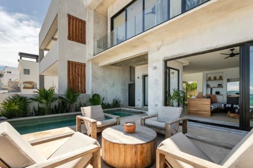 Casa Copal cottage patio with lounge chairs, wooden table, pool, and sea view in Isla Mujeres