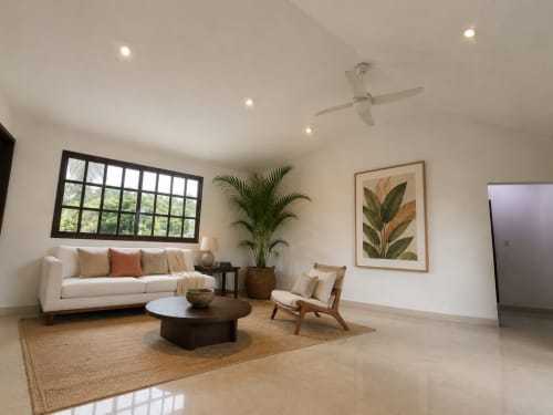 Modern living room at Hacienda las Golondrinas villa in Isla Mujeres with cream sofa, wood furniture, potted plant, and