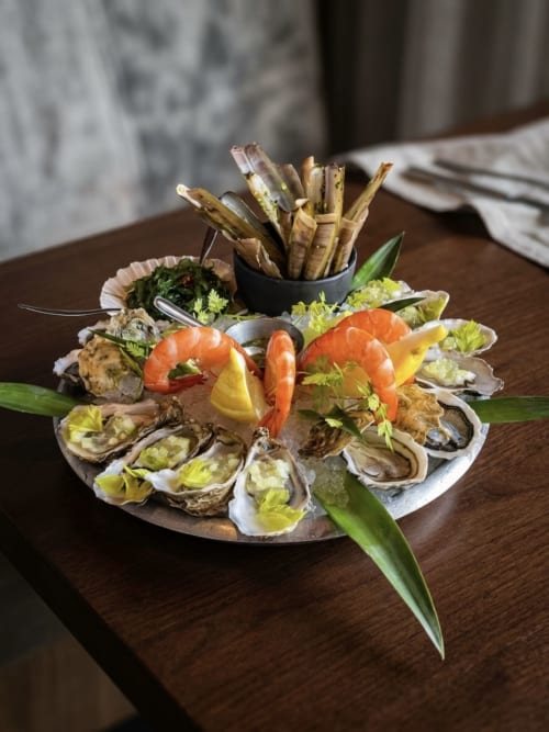 Elegant seafood platter with oysters, shrimp, and fried calamari at Hotel Beau Rivage, French Alps
