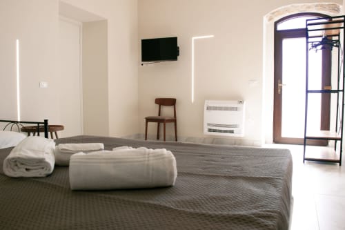 Suite spacieuse du Sikania Agri Relais à Caccamo avec lits jumeaux, TV, équipements modernes et vue montagne