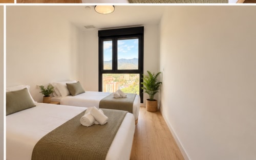 Moderno dormitorio doble en apartamento de Málaga con vistas a la montaña, ventanas con marco negro, ropa de cama blanca y plantas en macetas