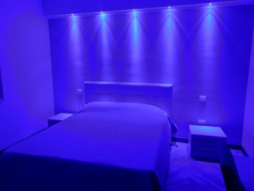 Modern bedroom with purple ambient lighting at Sweet Elite House, Scafati B&B. Double bed with nightstands under illuminated