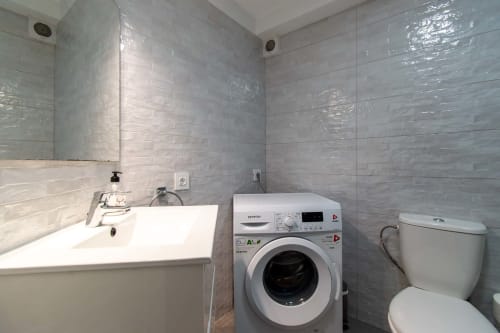 Modern bathroom in Sunny Studio apartment at Marigold Property Services, Costa Adeje, Tenerife, featuring washing machine,
