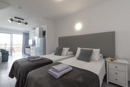 Modern studio apartment in Costa Adeje, Tenerife with twin beds, sea view balcony, and contemporary furnishings