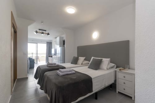 Modern studio apartment with twin beds, sea view balcony, and contemporary design at Marigold in Costa Adeje
