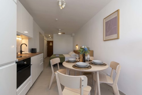 Modern studio apartment in Costa Adeje with dining area, kitchenette, and bedroom in open-plan layout