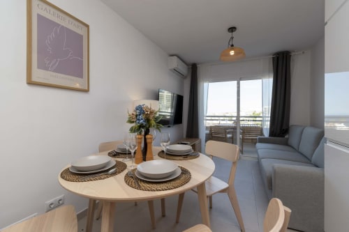 Modern studio apartment in Costa Adeje, Tenerife with dining area, sea view balcony, and contemporary furnishings