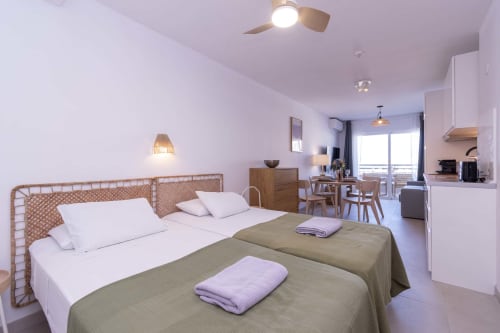 Refurbished studio apartment in Costa Adeje, Tenerife with twin beds, sea view balcony, dining area, and modern amenities