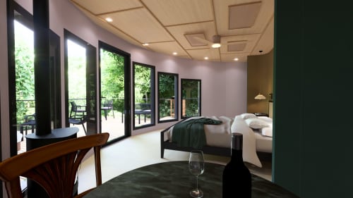 Chambre moderne du gîte Domaine Langelet avec vue sur jardin, lit, coin salon et portes-fenêtres ouvrant sur terrasse