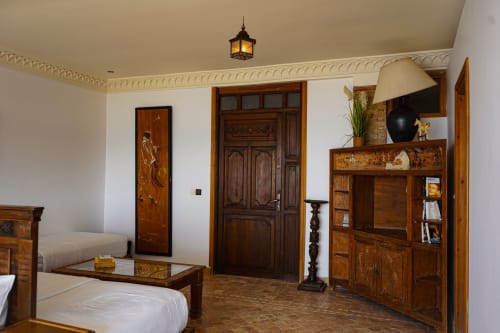 TAMSRITE room at Imsouane Surf Paradise with wooden furnishings, beamed ceiling, and ocean view, Agadir
