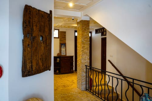 Imsouane Surf Paradise hallway with wooden doors, brick columns, and stairs leading to ocean view room