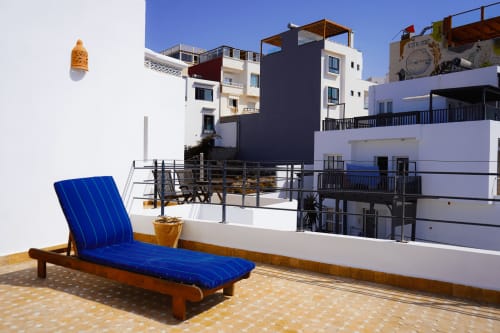 Blue lounger on terrace overlooking Imsouane sea view, Agadir Morocco hotel apartment balcony