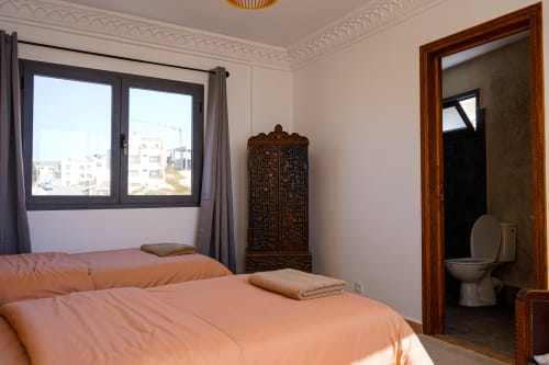 Tagante room at Imsouane Surf Paradise with sea view, double beds, ocean-facing window, and en-suite bathroom in Agadir,