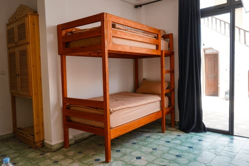 Wooden bunk beds in Loubana room at Imsouane Surf Paradise hotel, Agadir, Morocco with terrace access