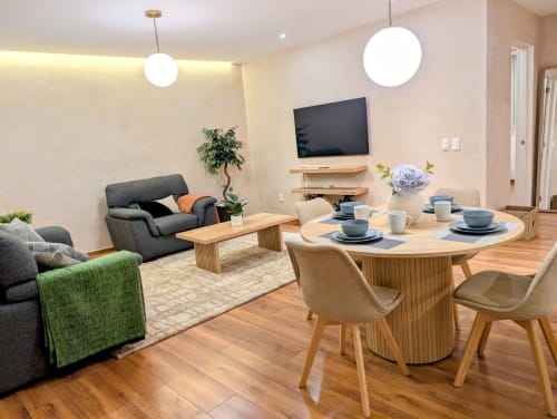 Moderna sala de estar del apartamento Casa Donceles en Ciudad de México con comedor, TV, asientos cómodos y diseño contemporáneo