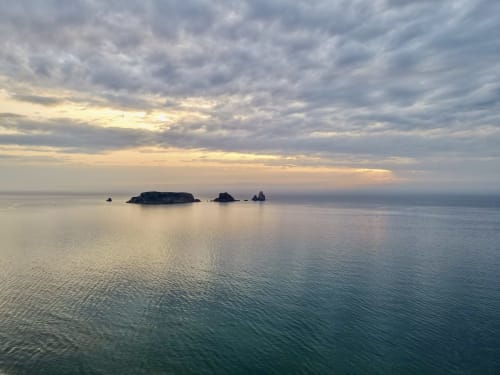 Serene sunset over Mediterranean Sea with rocky islands near Estartit cottage rental in Catalonia