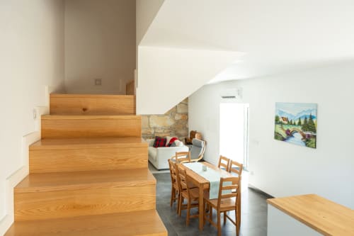 Wooden staircase in Casa da Eira cottage, Canhoto Douro, with dining area and mountain view artwork below