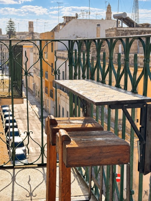 Balcony view from Aletium room at HABITARE Lecce, overlooking yellow buildings and Lecce's historic cityscape