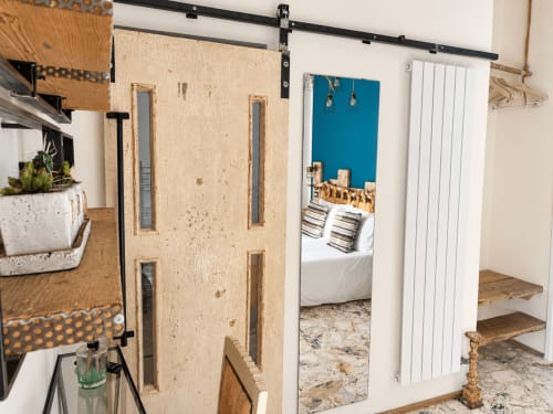 Camera ecologica moderna ad HABITARE Lecce con porta a soffietto scorrevole, parete azzurra e design contemporaneo nel Salento