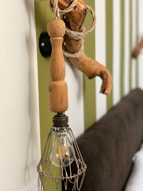 Vintage wooden whisk with rope hanging at HABITARE Lecce, showcasing rustic Mediterranean charm in the Olivum room