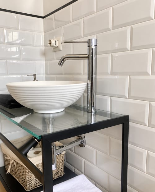 Modern bathroom sink with white ribbed ceramic bowl and chrome faucet at HABITARE Lecce boutique hotel in Salento, Italy