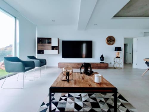Modern Tenerife apartment living room with turquoise chairs, flat-screen TV, wooden table, and pool views from Costa Adeje