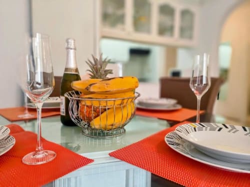 Elegant dining table at Manage Home Tenerife with champagne, bread basket, and place settings in Playa de las Américas