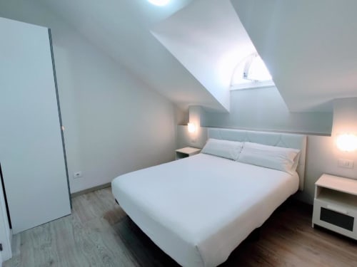 Modern attic bedroom at Manage Home Tenerife in Playa de las Américas with queen bed and skylight
