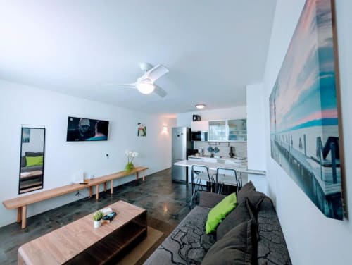 Modern apartment at Manage Home Tenerife in Arona with open-plan living, kitchen, dark sofa, wooden table, and pool-view