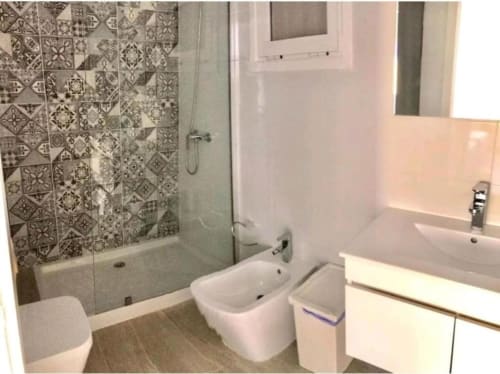 Modern bathroom at Manage Home Tenerife apartment in Los Cristianos with patterned tile shower and white fixtures