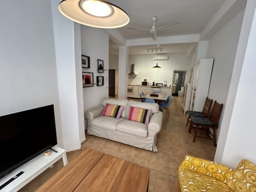 Amplio apartamento moderno en Sevilla con sofá beige, comedor y cocina abierta - Judería3 CozyHomeSevilla