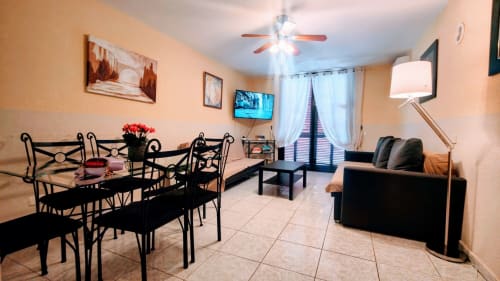 Duplex Duo apartment in Playa de las Américas featuring dining area, black furniture, living room with dark sofa, and ceiling